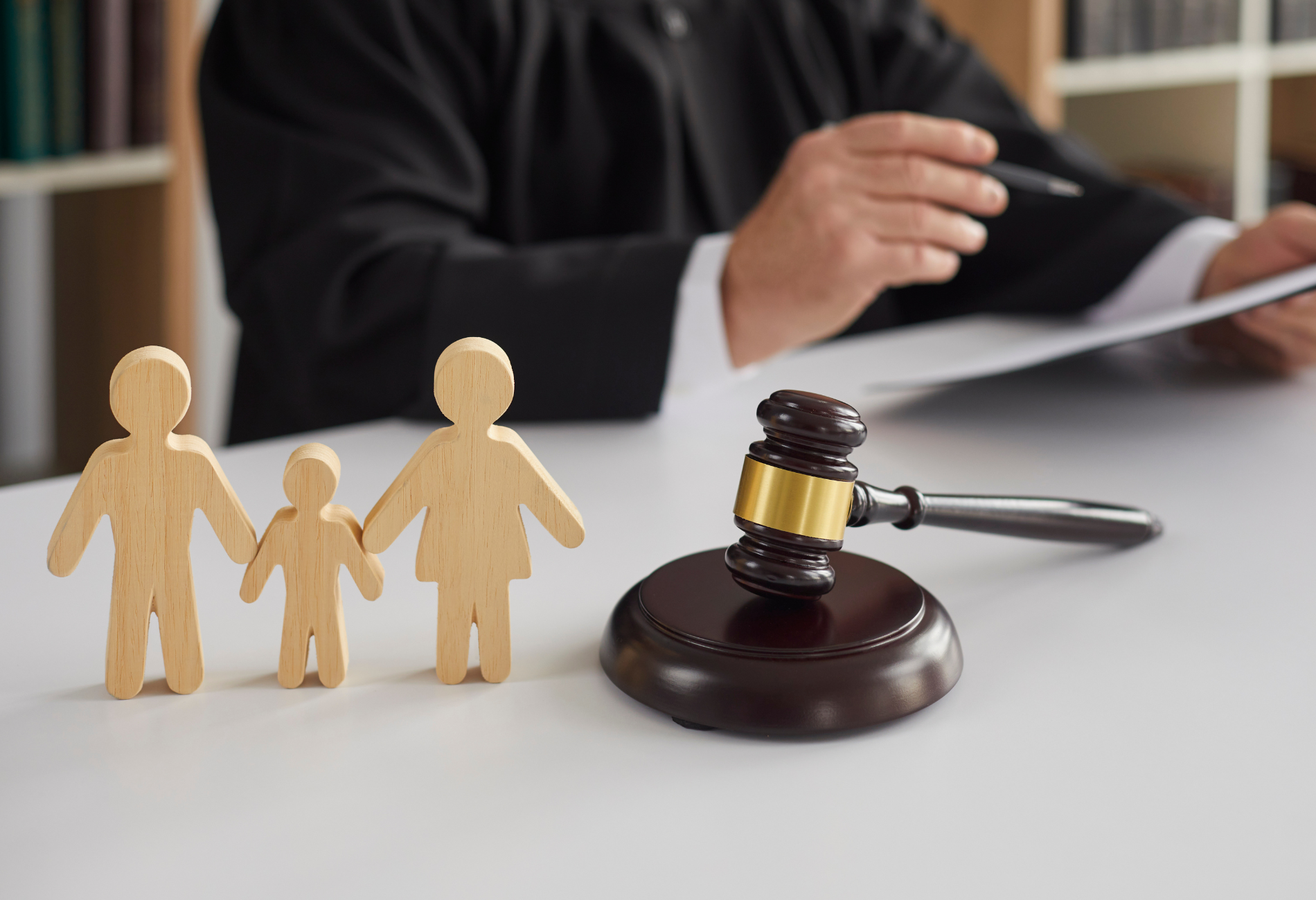 A lawyer is talking to a client while sitting at a table.