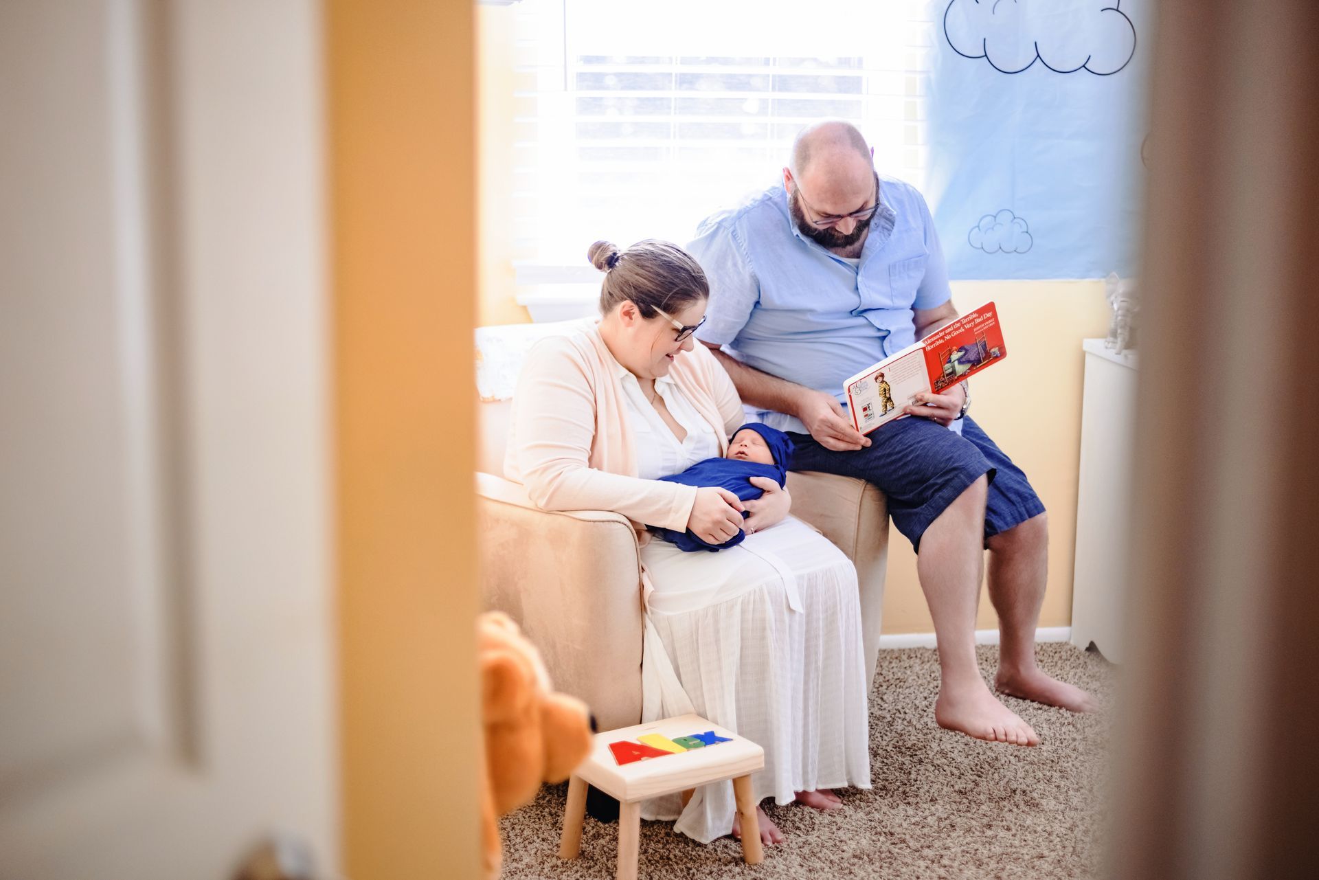 Adult and child playing a small guitar together in a bright living room