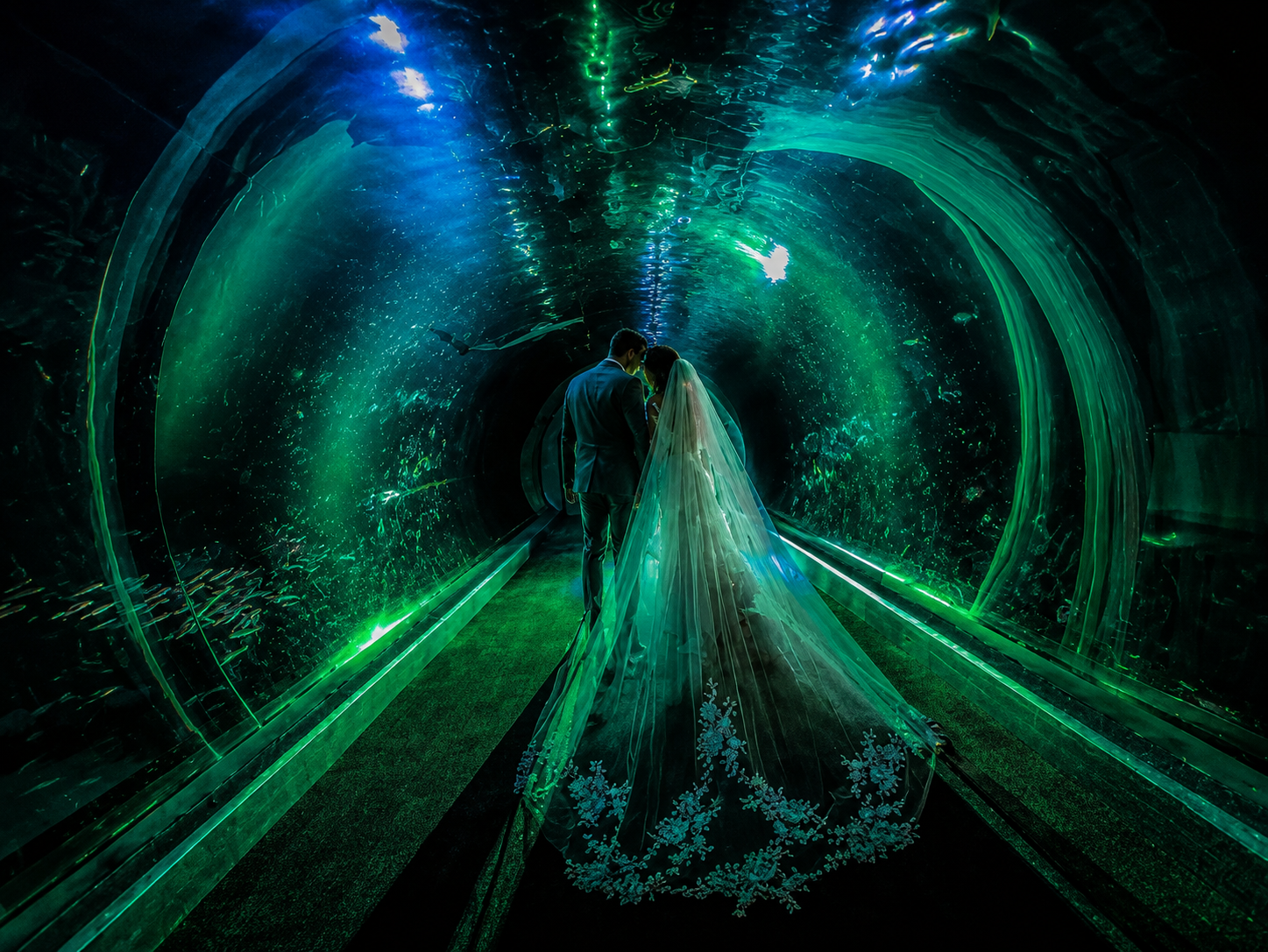 Green-lit tunnel with a glowing figure at the center and streaking light trails