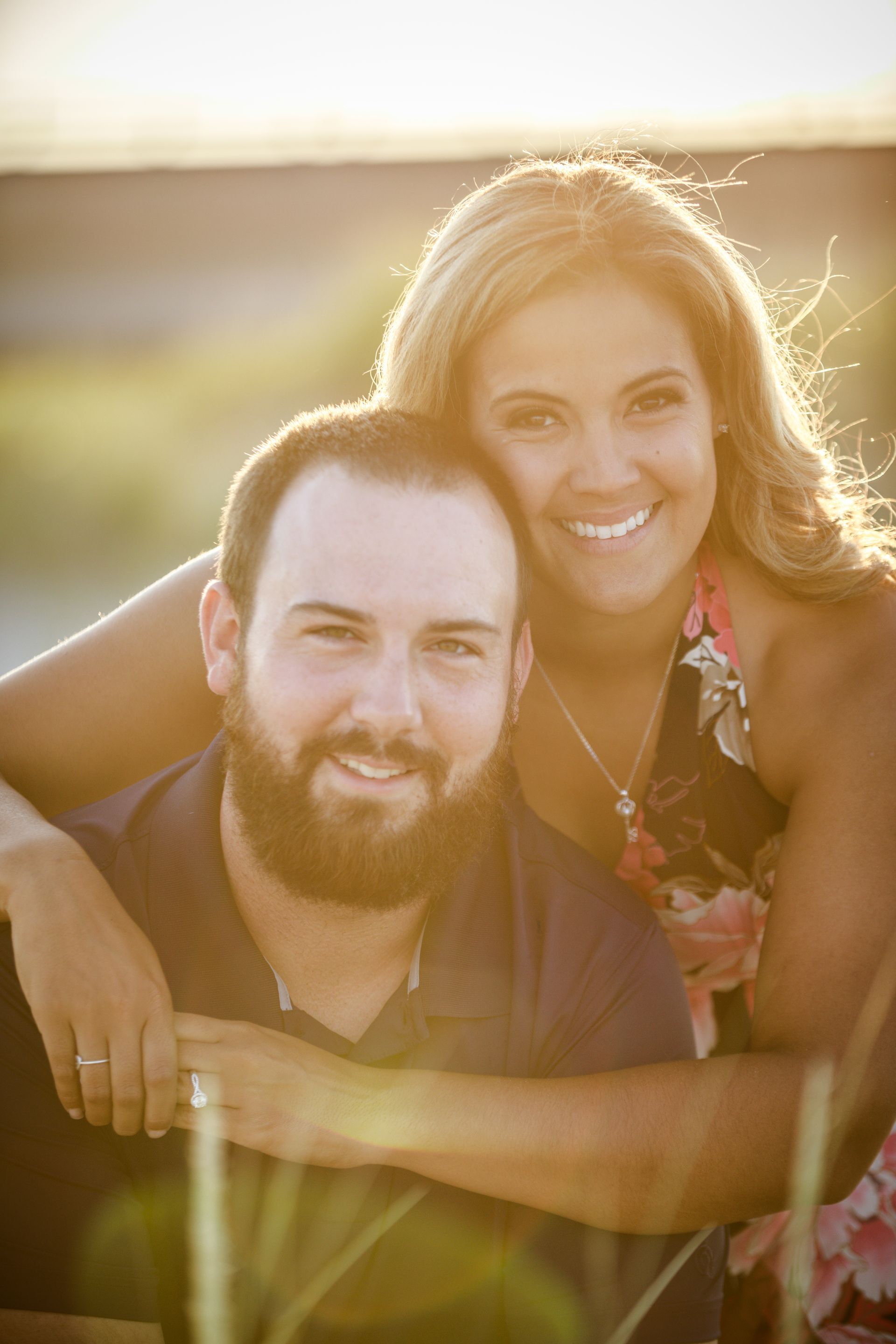 Smiling couple embracing outdoors in warm golden sunlight
