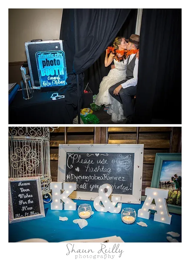 Photo booth at a party with a blue sign, and a decorated table with chalkboard signs, candles, and gold initials.