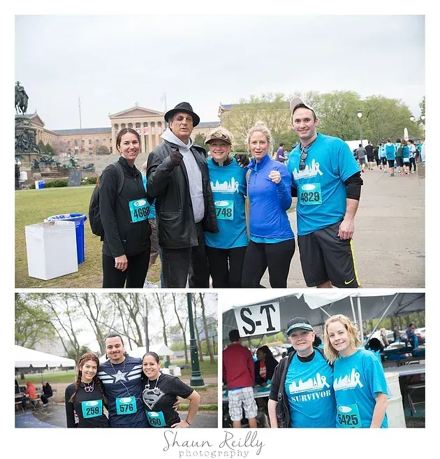 Five runners in teal shirts pose outdoors at a charity race event.