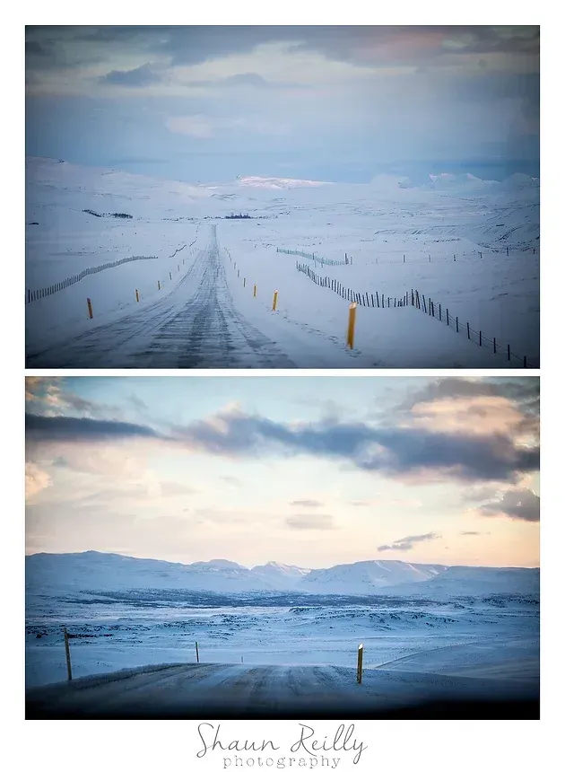Snow-covered road leading into misty mountains under a pastel sky, with fences along the sides