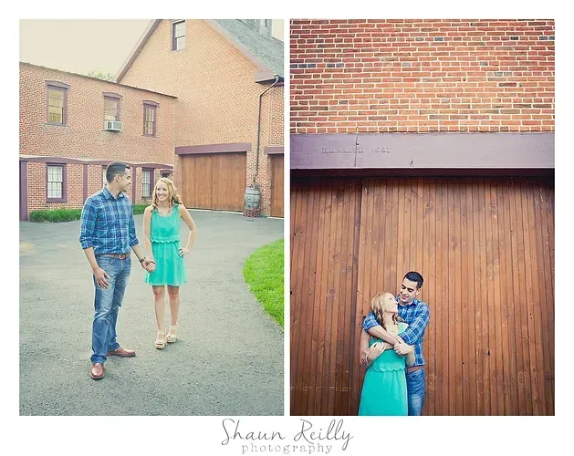 Couple holding hands and embracing in front of brick buildings and a wooden garage door