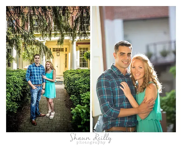 Couple posing outdoors in front of a house, wearing blue and teal outfits, smiling at the camera.