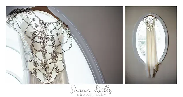 White lace hanging garment with pearl-beaded draping in an arched window
