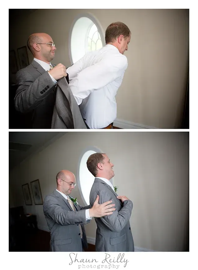 Two men in suits near a window, one helping the other put on a jacket, then adjusting it.