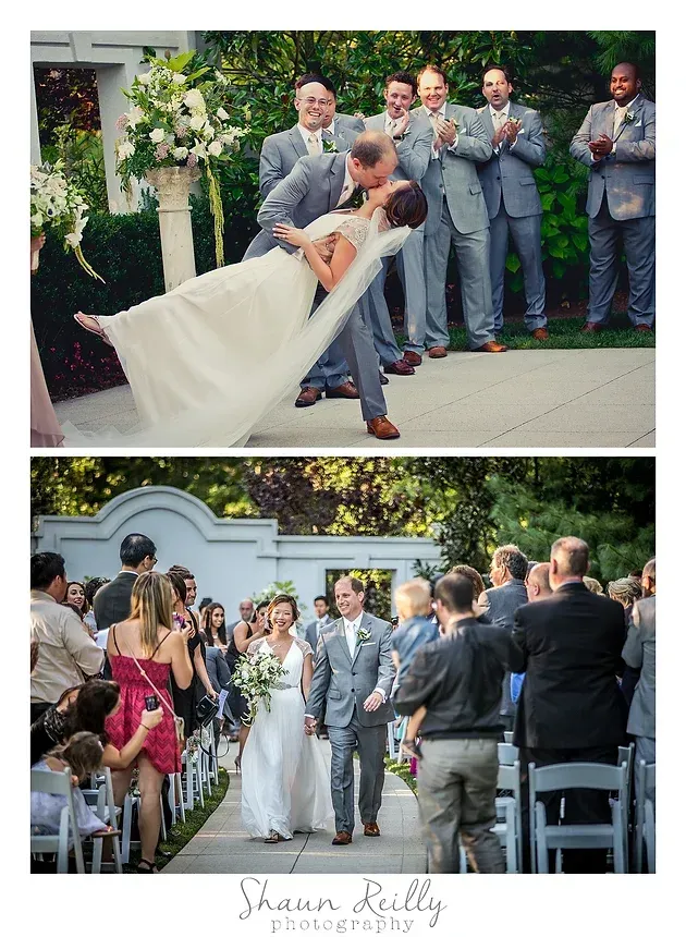 Wedding couple dancing dip as guests applaud outdoors; bride in white gown, groom in gray suit.