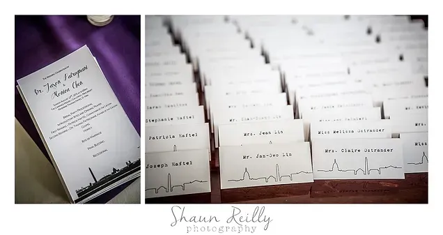 Wedding invitations on purple satin, with elegant white cards and handwritten place cards arranged in rows.