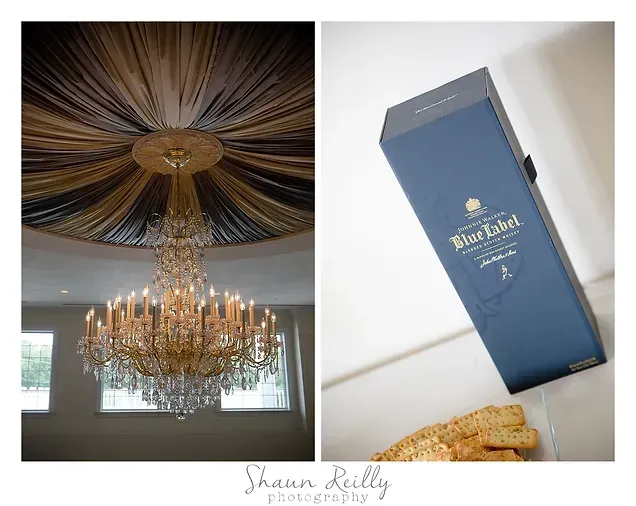 Elegant gold chandelier under draped ceiling beside a blue wedding invitation and gold accessories