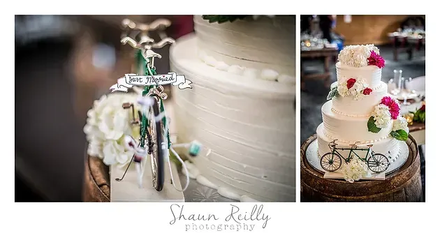 Vintage wedding cake with white frosting and flowers on a bicycle-themed table display