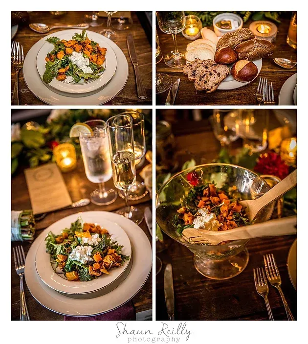 Warm candlelit table with plated salad, bread, and drinks in a cozy restaurant setting