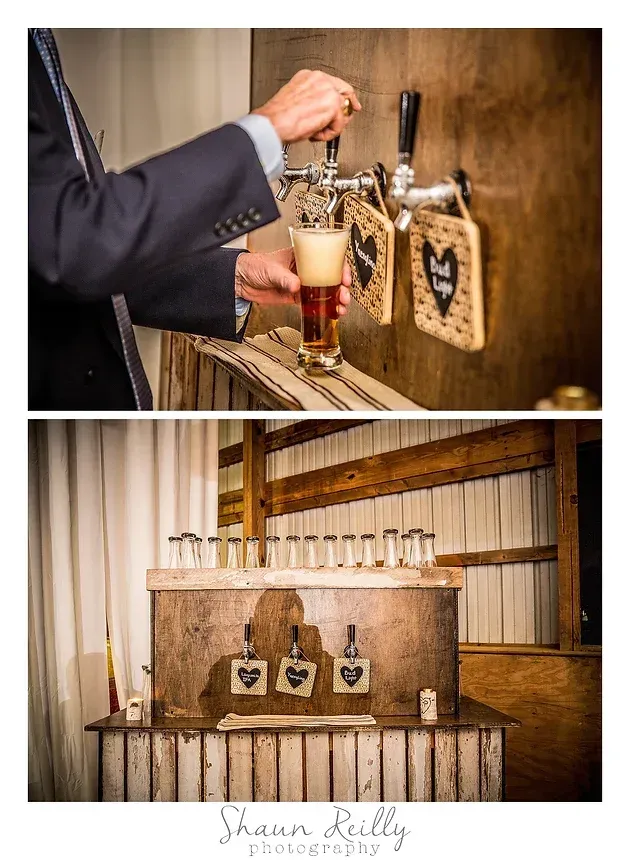 Bartender pours beer from tap into a glass; two wooden keg taps displayed in rustic indoor setting.