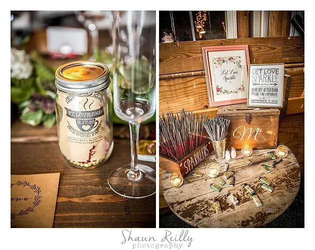 Rustic candle and packaged favors on a wooden table with champagne flute and floral decor.