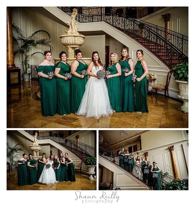 Wedding party portrait in a grand staircase foyer, with bride in white and bridesmaids in green dresses