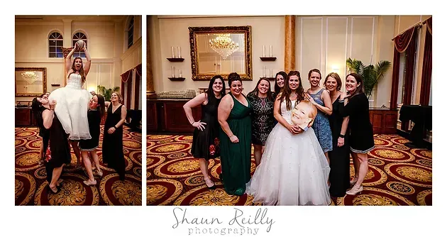 Wedding party posing in a hotel lobby, with the bride and attendants in formal attire.