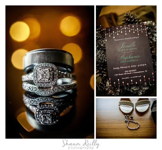 Wedding rings and invitation styled with warm bokeh lights on a wooden table
