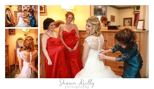 Bride in white gown with bridesmaids in red dresses getting ready in a warmly lit room