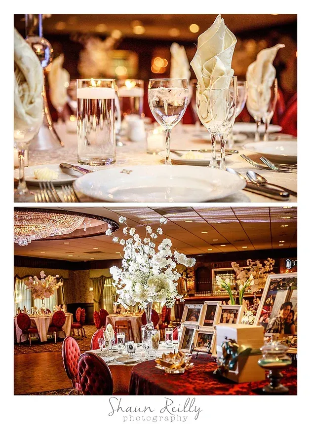 Elegant banquet table set with candles, glassware, and folded napkins in a warmly lit reception hall
