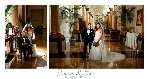 Wedding couple posing in an elegant hallway with columns and warm lighting