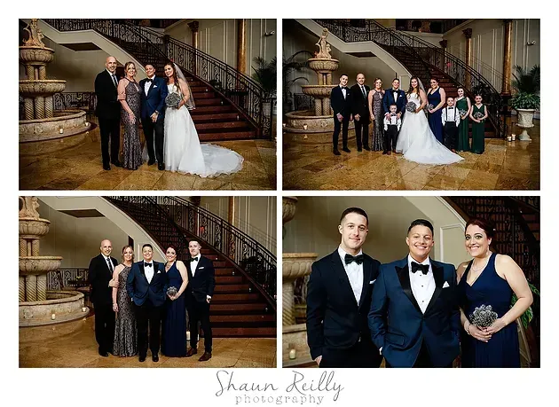 Wedding party posing in a grand stairway lobby, with bride in white gown and groom in dark tuxedo.