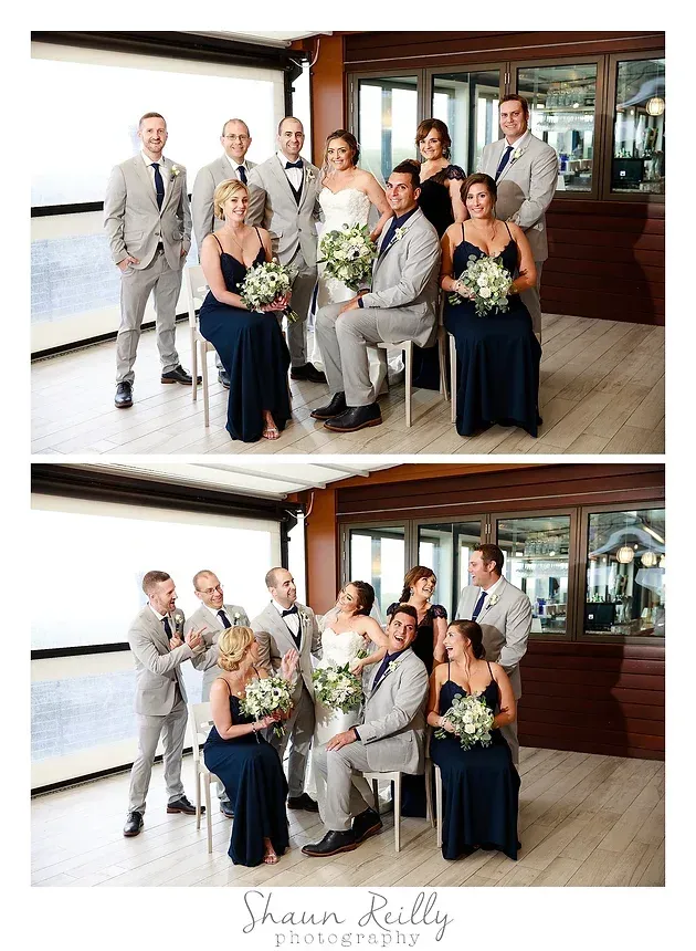 Wedding party posing indoors in formal attire, holding bouquets and smiling near a wooden wall.