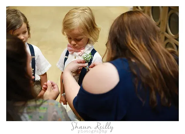 Children exchanging flowers in a warmly lit indoor setting