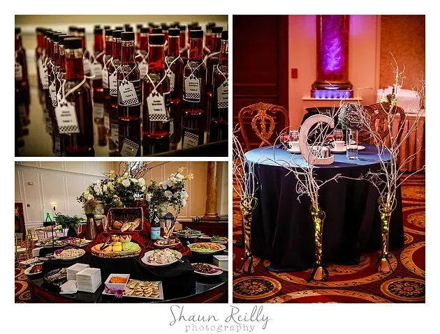 Wine display and decorated banquet tables in a warmly lit event hall
