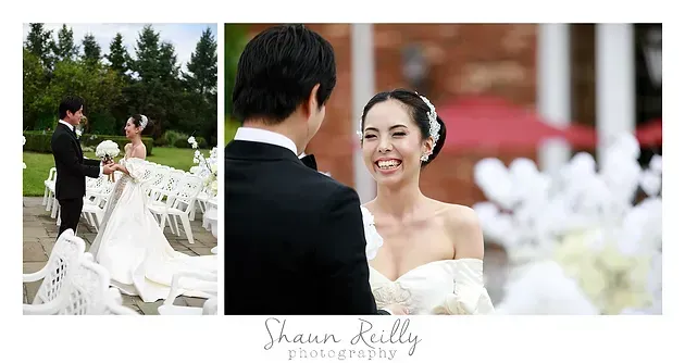 Bride smiles at groom during outdoor wedding ceremony beside white chairs and flowers