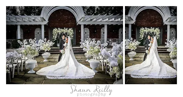 Bride in white gown on mirrored outdoor wedding aisle with flowers and chandeliers