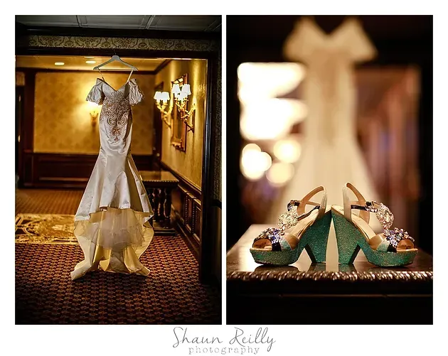 Wedding dress and green heels displayed in a warm, elegant bridal room