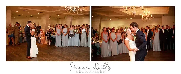 Bride and groom share a dance at a wedding reception as guests watch and clap