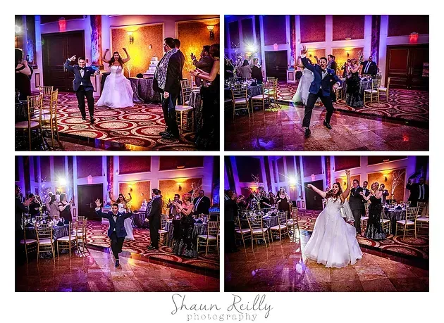 Wedding reception dance floor with bride and guests under purple and warm stage lighting