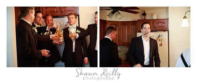 Men in suits and tuxedos raise drinks in a wood-paneled room at a wedding reception