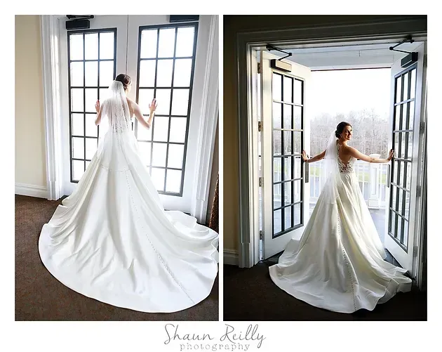 Bride in white gown with long train by tall windows, shown from back and in profile by open doors