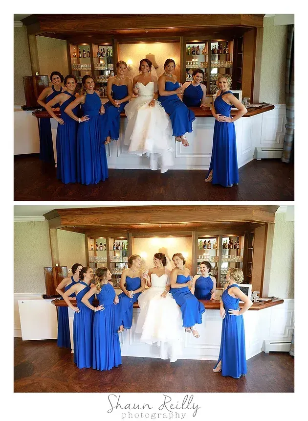 Wedding party posing in a rustic room, with bridesmaids in blue and the bride in a white gown.
