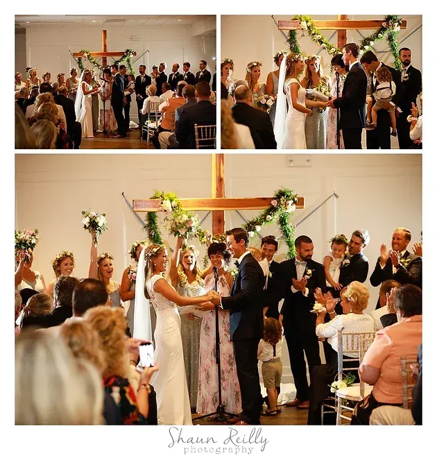 Wedding ceremony in a church, bride and groom exchanging vows before a large wooden cross