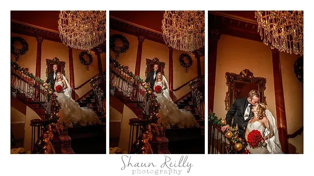 Bride in white dress descending ornate staircase beneath chandelier in warm, dimly lit interior
