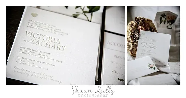 Elegant wedding invitation suite in cream and gold, arranged with envelopes, ribbon, and dried florals on a white surface