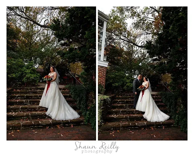 Couple in formal wedding attire posing on stone steps beneath trees, with a bouquet and white gown.