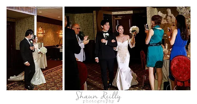 Wedding reception with couple dancing and guests applauding in a warmly lit venue
