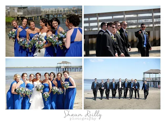 Wedding party posing on a beach boardwalk, with bridesmaids in blue and groomsmen in suits.