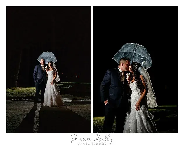 Bride and groom sharing an umbrella during a nighttime wedding photo shoot