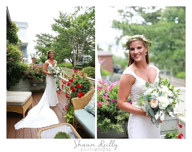 Bride in white gown holding a bouquet, posing on a garden walkway with flowers and greenery.