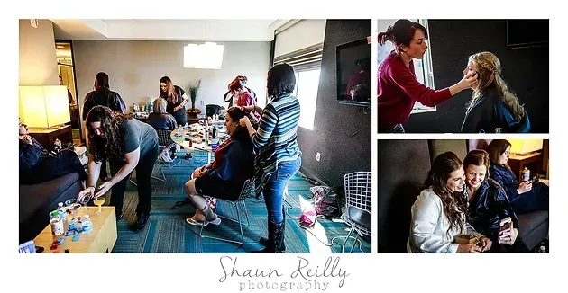 Bridal party getting ready in a bright room, with a stylist working on a seated woman and friends chatting nearby