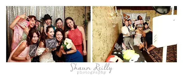 Group of friends posing at a party photo booth, smiling with playful props before a gold backdrop.