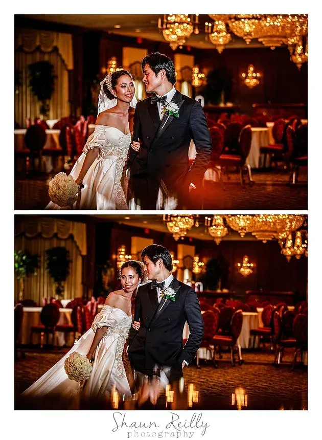 Bride and groom posing in an ornate, warmly lit ballroom at a wedding reception