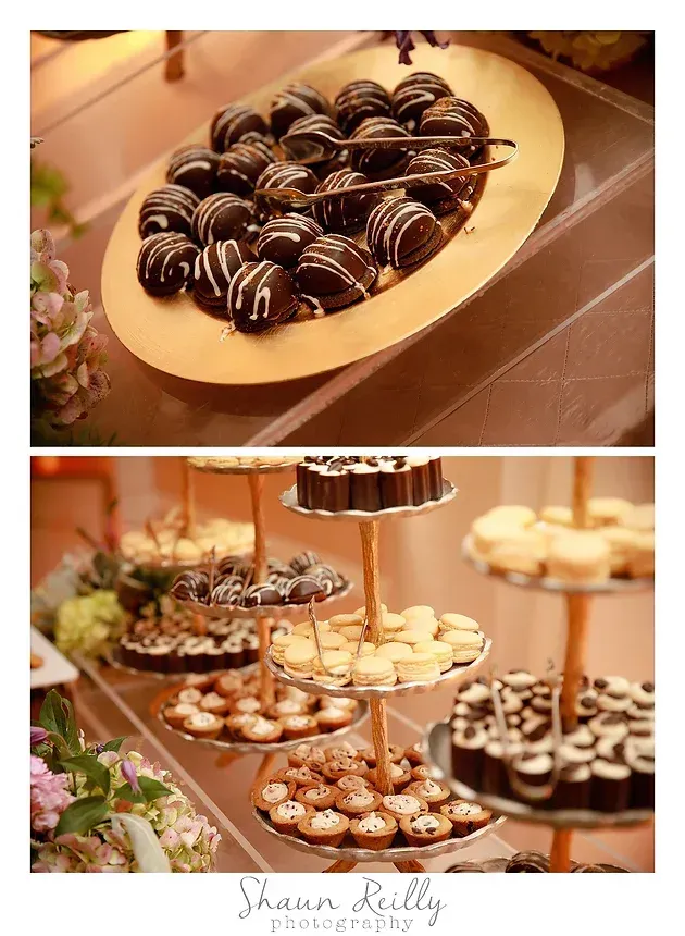 Dessert buffet with chocolate-dipped treats and assorted pastries on tiered stands and trays