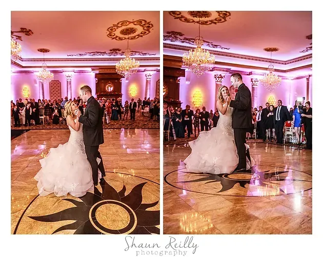Bride and groom dancing in a pink-lit ballroom wedding reception