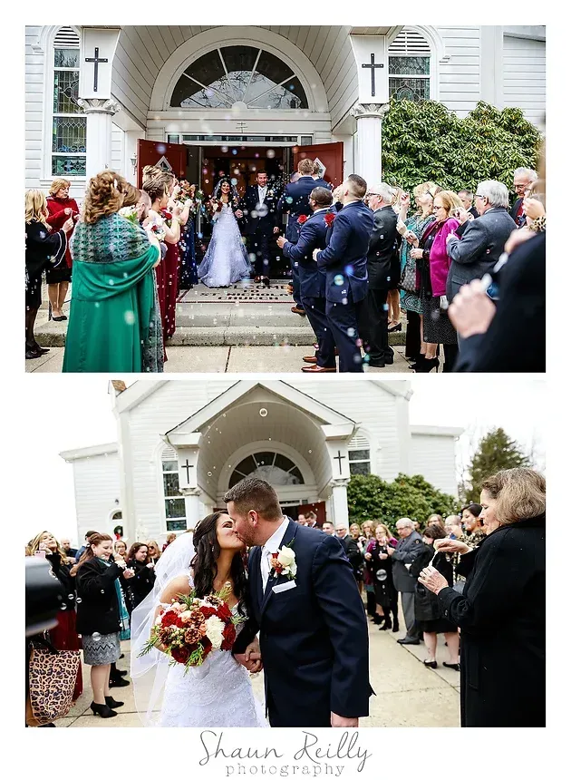 Wedding ceremony at church entrance, with guests gathered and bride and groom kissing on the steps